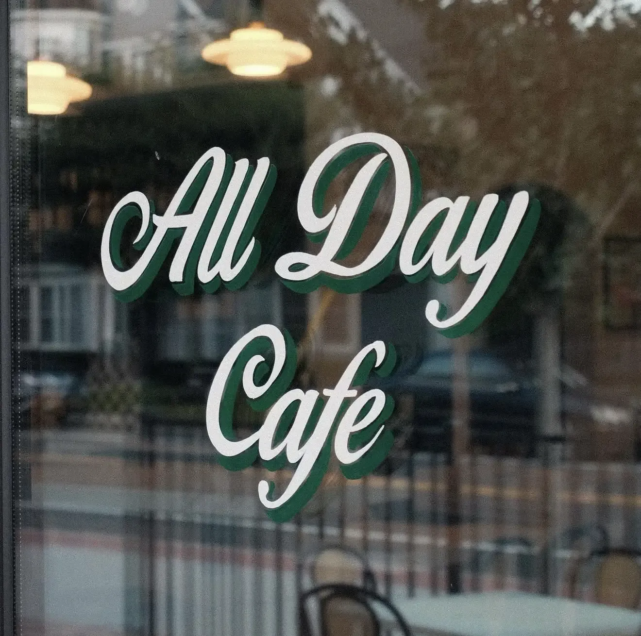 The All Day Cafe script painted on the Roto storefront window